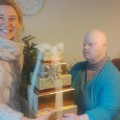 Alison with Christmas presents and her carer, Jurgita